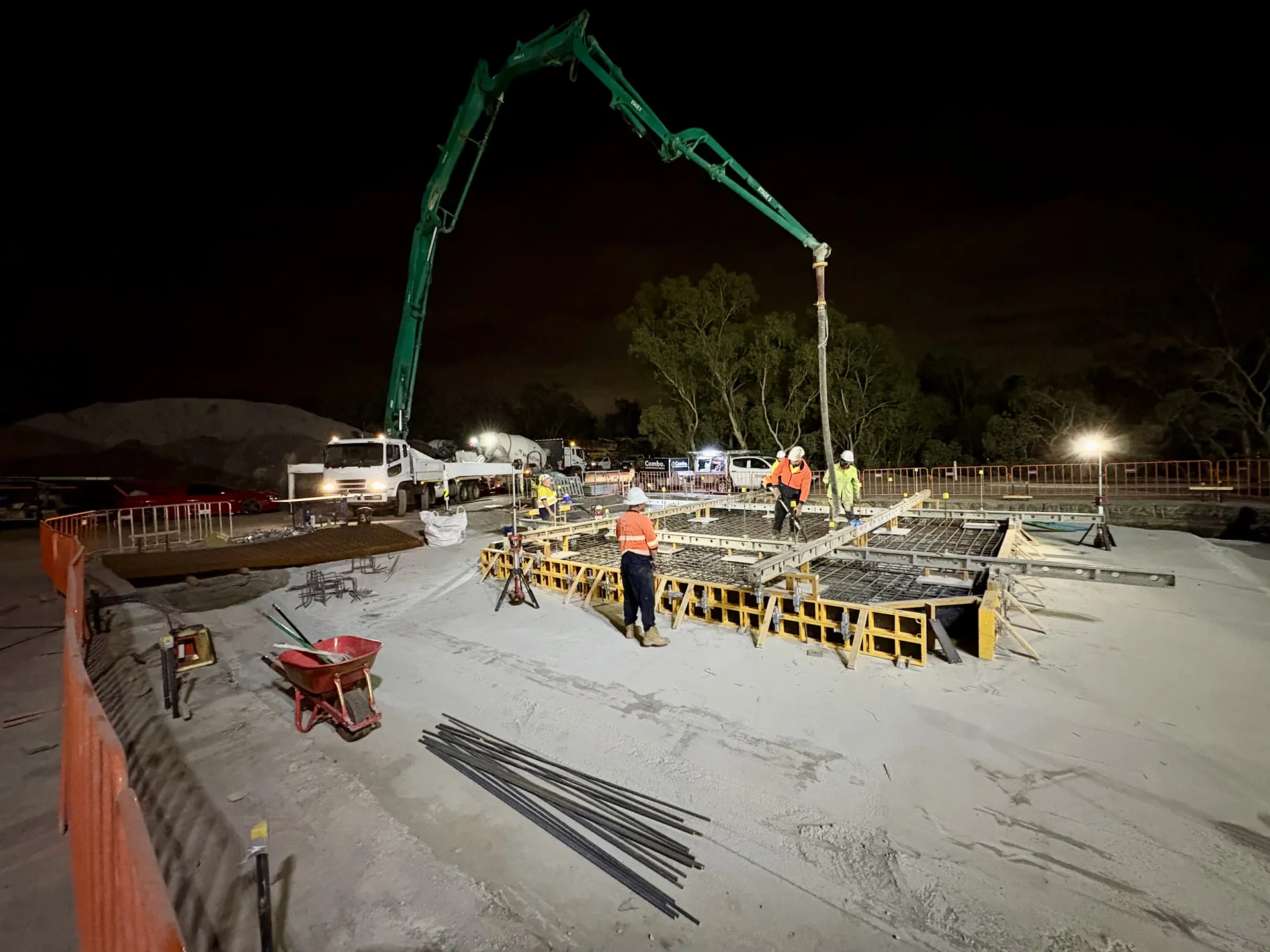 Night concrete pour with a boom pump at a Combo Constructions civil site